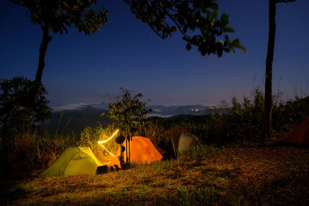 Mountain at night time with camping tents